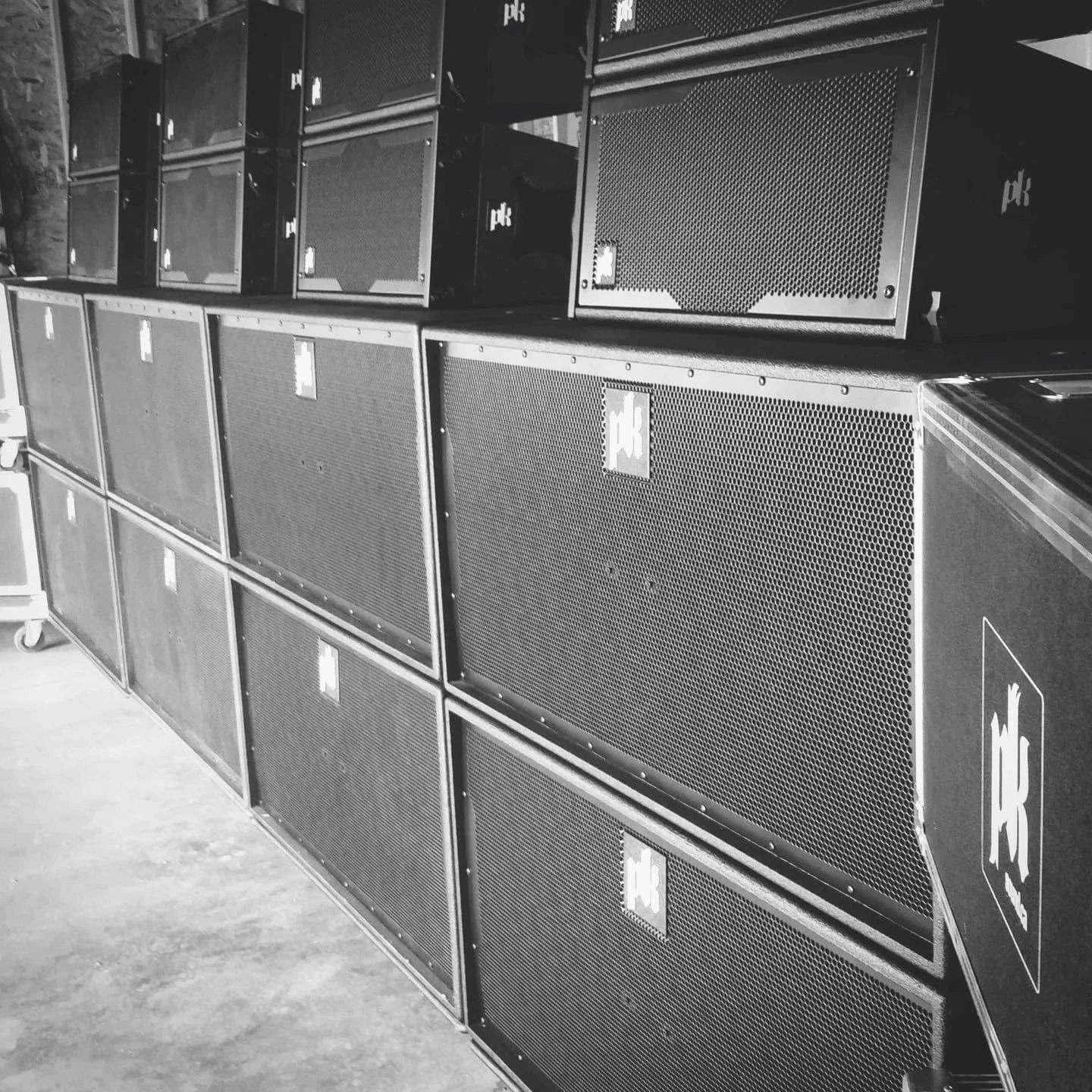 A wall of PK Sound subwoofers stacked for a Foundation show