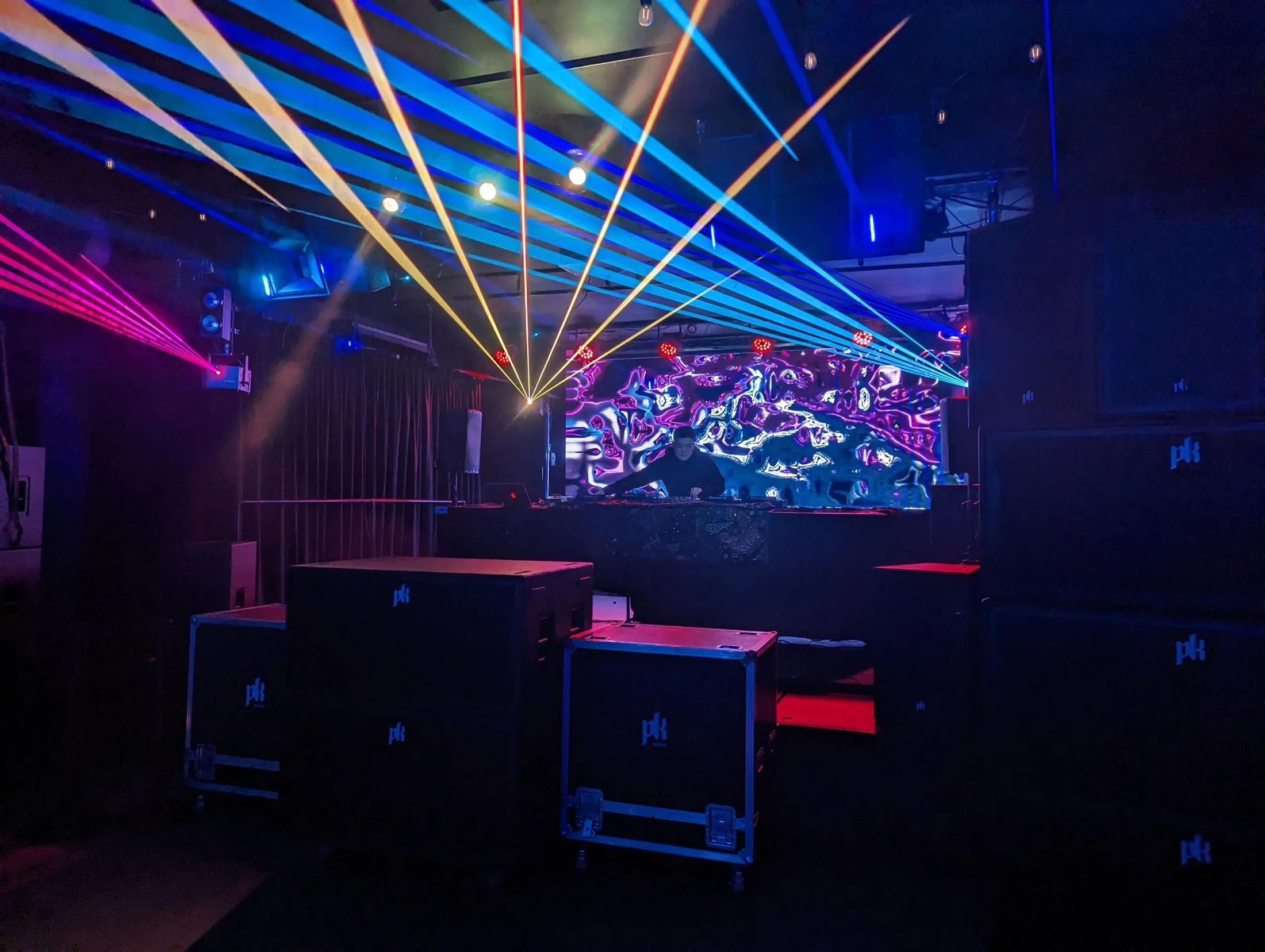 Lasers over the DJ booth with PK Sound cabinets stacked in front